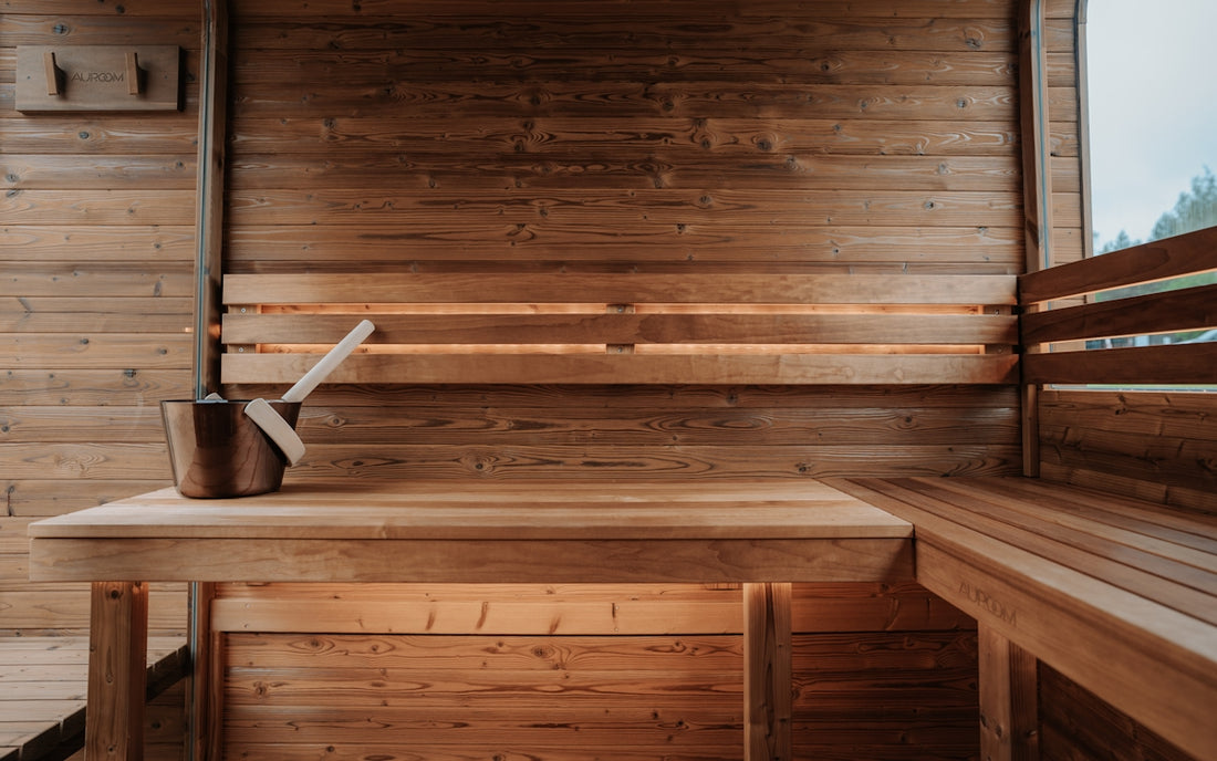 Wooden sauna interior with bucket and ladle.